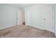 This bedroom features neutral carpet, light blue walls, and doors leading to the hallway and closet at 12848 Patrick Ct, Fishers, IN 46038