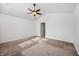 A large carpeted bedroom featuring a fan and a doorway to another room at 12848 Patrick Ct, Fishers, IN 46038
