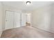 Carpeted bedroom with double closet doors and neutral walls with an open door to an adjacent room at 12848 Patrick Ct, Fishers, IN 46038