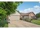 Lovely single-story home featuring a well-maintained lawn, brick details, and an attached two-car garage at 12848 Patrick Ct, Fishers, IN 46038