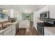 Inviting kitchen with stainless steel appliances, white cabinetry and view to backyard at 12848 Patrick Ct, Fishers, IN 46038