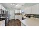 Bright kitchen features stainless steel appliances, white cabinets and dark backsplash at 12848 Patrick Ct, Fishers, IN 46038