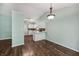 Open kitchen featuring stainless appliances, white cabinets, wood flooring, and an inviting breakfast bar at 12848 Patrick Ct, Fishers, IN 46038
