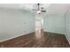 Open-concept living room with hardwood floors, ceiling fan, and view into other rooms at 12848 Patrick Ct, Fishers, IN 46038