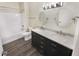 Bright bathroom featuring a double sink vanity with marble countertop and wood look flooring at 1359 Shadow Ridge Rd, Indianapolis, IN 46280