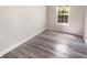 Neutral bedroom featuring a window letting in natural light and wood look flooring at 1359 Shadow Ridge Rd, Indianapolis, IN 46280