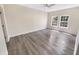 Bright, empty bedroom with hardwood floors and two windows providing natural light at 1359 Shadow Ridge Rd, Indianapolis, IN 46280