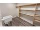 Laundry room featuring utility sink and built in shelving with wood look flooring at 1359 Shadow Ridge Rd, Indianapolis, IN 46280