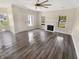 Open living room with fireplace, many windows, and wood-look flooring at 1359 Shadow Ridge Rd, Indianapolis, IN 46280