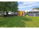 Spacious backyard with a modern house and lush green grass, perfect for outdoor activities at 1409 N Grant Ave, Indianapolis, IN 46201
