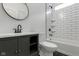 Modern bathroom featuring a vanity, toilet, and tiled shower/tub combo with updated fixtures at 1409 N Grant Ave, Indianapolis, IN 46201