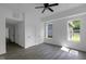 Bright bedroom featuring two windows, a ceiling fan, and gray floors for a comfortable living space at 1409 N Grant Ave, Indianapolis, IN 46201