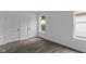 Bright bedroom boasts hardwood floors, white walls, two closets, and is illuminated by natural light at 1409 N Grant Ave, Indianapolis, IN 46201
