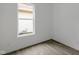 Cozy bedroom featuring hardwood floors, white walls, and a large window offering exterior views at 1409 N Grant Ave, Indianapolis, IN 46201