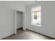Bright bedroom features hardwood floors, a closet with louvered doors, and a window to the exterior at 1409 N Grant Ave, Indianapolis, IN 46201