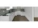Bright kitchen featuring white cabinets, granite countertops, and decorative tile backsplash at 1409 N Grant Ave, Indianapolis, IN 46201
