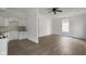Sunlit living room with hardwood floors seamlessly connects to a kitchen featuring white cabinets at 1409 N Grant Ave, Indianapolis, IN 46201