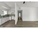 Open-concept living area with hardwood floors seamlessly connects to the kitchen with white cabinets at 1409 N Grant Ave, Indianapolis, IN 46201