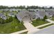 Aerial view of a charming home with a well-kept lawn and a nearby pond at 16209 Natures Way, Westfield, IN 46074