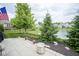 Paved backyard patio with lake view and manicured greenery, perfect for relaxing at 16209 Natures Way, Westfield, IN 46074