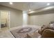 Spacious finished basement with neutral walls and carpet with two sitting chairs and area rug at 16209 Natures Way, Westfield, IN 46074
