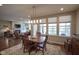 Open dining room features wood table, chair set, rug, and natural light from the windows at 16209 Natures Way, Westfield, IN 46074