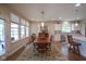 Dining room flows into kitchen featuring wood floors, area rug, pendant lighting, and natural light at 16209 Natures Way, Westfield, IN 46074