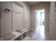 Inviting entryway with built-in bench and coat rack, leading to a naturally lit room at 16209 Natures Way, Westfield, IN 46074