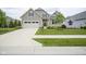 Charming home features a manicured lawn, two-car garage, and inviting walkway at 16209 Natures Way, Westfield, IN 46074