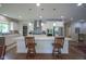 Spacious kitchen island with white cabinets, stone countertop, pendant lights and seating for two at 16209 Natures Way, Westfield, IN 46074