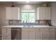 Bright kitchen features white cabinets, stainless steel appliances, granite countertops and window over sink at 16209 Natures Way, Westfield, IN 46074