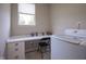 Bright laundry area featuring white countertops, drawers, and nearby washer and dryer at 16209 Natures Way, Westfield, IN 46074