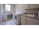 Efficient laundry room with modern washer/dryer, built-in desk, and ample storage cabinets at 16209 Natures Way, Westfield, IN 46074
