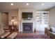Cozy living room with fireplace, built-in shelving, wood floors and comfortable seating at 16209 Natures Way, Westfield, IN 46074