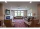 Spacious living room with a fireplace, built-in shelving, comfortable seating, and natural lighting at 16209 Natures Way, Westfield, IN 46074