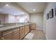 Basement wet bar with granite counters, stainless steel sink, wood cabinets, and stainless dishwasher at 16209 Natures Way, Westfield, IN 46074