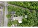 Aerial view of a wooded residential property adjacent to a road and railroad tracks at 1631 S Post Rd, Indianapolis, IN 46239