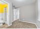 Cozy bedroom with gray walls and plush carpeting, featuring an adjoining bathroom with yellow wall accents at 1631 S Post Rd, Indianapolis, IN 46239
