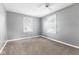 Large bedroom with gray walls, plush carpeting, two windows with blinds, and a ceiling fan at 1631 S Post Rd, Indianapolis, IN 46239