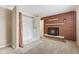 Open bedroom with tiled floor shower and brick fireplace at 1631 S Post Rd, Indianapolis, IN 46239