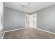Bright bedroom with gray walls, plush carpeting, a ceiling fan, and a view into the hallway at 1631 S Post Rd, Indianapolis, IN 46239