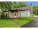 Charming stone-clad home with well-manicured lawn and a classic chimney at 1631 S Post Rd, Indianapolis, IN 46239