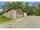 Detached garage with ample parking space, surrounded by a gravel yard at 1631 S Post Rd, Indianapolis, IN 46239