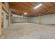 Bright, unfinished garage interior with a gravel floor and open ceiling at 1631 S Post Rd, Indianapolis, IN 46239