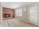 Cozy living room with brick fireplace, large window, and access to outdoor area at 1631 S Post Rd, Indianapolis, IN 46239