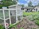 Backyard features a charming chicken coop, blending functionality with rustic charm and garden space at 1802 Laurel Dr, Columbus, IN 47203