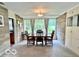 Bright dining room with stone walls, a large window, and a classic dining set at 1802 Laurel Dr, Columbus, IN 47203