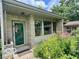 Stone exterior with a decorative front door and lush flower garden leading to the entrance at 1802 Laurel Dr, Columbus, IN 47203