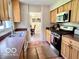 Functional kitchen featuring stainless steel appliances, ample cabinetry, and a view into the dining area at 1802 Laurel Dr, Columbus, IN 47203