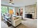 Inviting living room featuring neutral decor, stone fireplace, and view to bedroom at 1802 Laurel Dr, Columbus, IN 47203